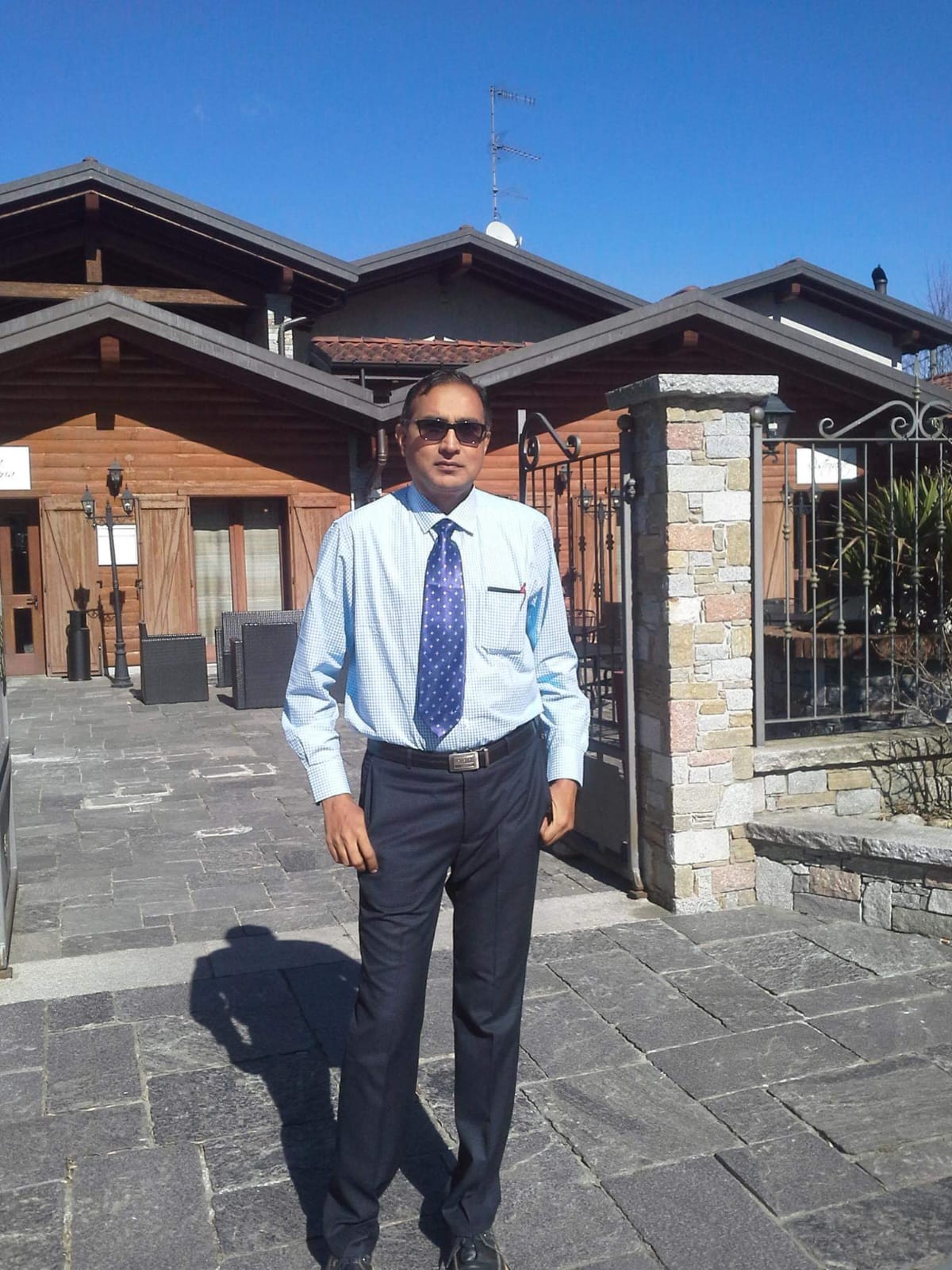 B.S. Kumaraswamy standing outdoors with sunglasses